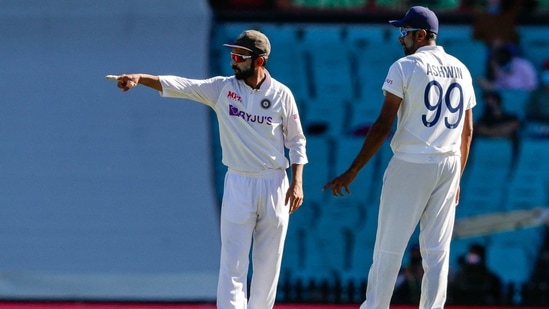 Indian captain Ajinkya Rahane gestures as he talks with bowler Ravichandran Ashwin during play on day three of the third cricket test between India and Australia at the Sydney Cricket Ground(AP)