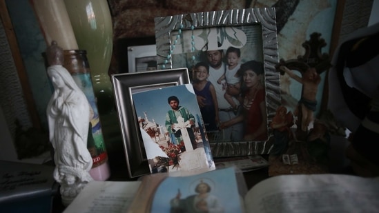Pictures of Jaime Aguilar Rojas, who was 50 when he died of Covid-19 in November, adorn an altar in the home of his son, Jaime Walfre Aguilar Martinez on January 11. Years ago, as Ciudad Juarez suffered jarring levels of violence, Guerrero started making the bears from clothing those victims had worn. (Christian Chavez / AP) Pictures of Jaime Aguilar Rojas, who was 50 when he died of Covid-19 in November, adorn an altar in the home of his son, Jaime Walfre Aguilar Martinez on January 11. Years ago, as Ciudad Juarez suffered jarring levels of violence, Guerrero started making the bears from clothing those victims had worn. (Christian Chavez / AP)