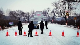 Security personnel direct a commuter in Ang'angxi district as the province prepares to declare an "emergency state" asking residents not to leave unless necessary in Qiqihar, Heilongjiang province, China on January 12. China recorded its biggest daily jump in Covid-19 cases in more than five months on January 13, stepping up containment measures that have seen four cities put under lockdown.