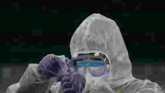 A doctor prepares coronavirus testing for residents.