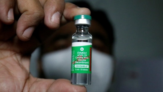 An official displays a vial containing Covid-19 vaccine COVISHIELD manufactured by Serum Institute of India, inside a vaccination storage centre in Ahmedabad on January 12. The first vials of the Covid-19 vaccine made by Pune-based Serum Institute of India (SII) reached 13 cities in India on January 12 ahead of a mass immunisation programme scheduled to begin on January 16.(Amit Dave / REUTERS)