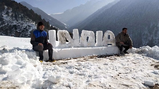 People pose for photos with India written with Snow, in Srinagar on Wednesday. (ANI Photo) People pose for photos with India written with Snow, in Srinagar on Wednesday. (ANI Photo)