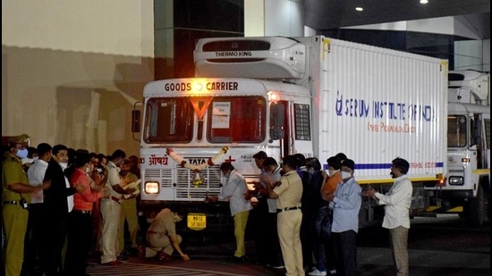 A police officer performs prayers in front of a truck carrying first consignment of Covishield, before it leaves Serum Bio-Pharma Park of Serum Institute of India, for its distribution, in Pune on January 12. (Reuters) A police officer performs prayers in front of a truck carrying first consignment of Covishield, before it leaves Serum Bio-Pharma Park of Serum Institute of India, for its distribution, in Pune on January 12. (Reuters)