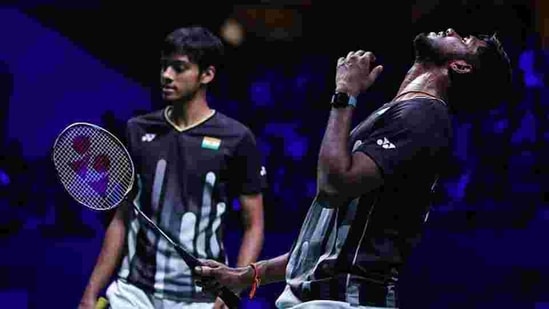 Satwiksairaj Rankireddy(R) and Chirag Shetty of India react after winning a point.(Getty Images)