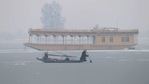 A Kashmiri boatman uses an oar to break the ice layer waters of Dal Lake after a snowfall, in Srinagar on Sunday. (ANI Photo) A Kashmiri boatman uses an oar to break the ice layer waters of Dal Lake after a snowfall, in Srinagar on Sunday. (ANI Photo)