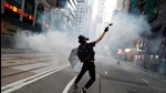 An anti-government protester reacts as police fire tear gas during a march billed as a global An anti-government protester reacts as police fire tear gas during a march billed as a global
