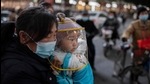 A woman wearing a face mask holds a baby that wears a protective shield during rush hour on a street outside of a shopping mall complex in the Chinese city of Wuhan on January 13. (AFP) A woman wearing a face mask holds a baby that wears a protective shield during rush hour on a street outside of a shopping mall complex in the Chinese city of Wuhan on January 13. (AFP)