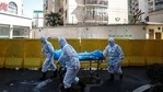 Medical workers move a person who died from Covid-19 at a hospital in Wuhan in central China's Hubei province. (AP/ File photo) Medical workers move a person who died from Covid-19 at a hospital in Wuhan in central China's Hubei province. (AP/ File photo)