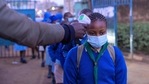 Students of Olympic Primary School wait in a line to have their temperatures measured at the entrance of the school in the early morning of the official re-opening day of public schools on January 4, 2021, in Kibera slum, Kenya, as students return to school following a nine-month closure ordered by the government in March 2020 to curb the spread of the COVID-19 coronavirus. (Photo by Gordwin ODHIAMBO / AFP)(AFP) Students of Olympic Primary School wait in a line to have their temperatures measured at the entrance of the school in the early morning of the official re-opening day of public schools on January 4, 2021, in Kibera slum, Kenya, as students return to school following a nine-month closure ordered by the government in March 2020 to curb the spread of the COVID-19 coronavirus. (Photo by Gordwin ODHIAMBO / AFP)(AFP)