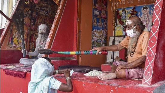 A pilgrim seeks blessings from a priest after a holy dip in Ganga during Ganga Sagar Mela, in South 24 Parganas district of West Bengal on January 13. (PTI) A pilgrim seeks blessings from a priest after a holy dip in Ganga during Ganga Sagar Mela, in South 24 Parganas district of West Bengal on January 13. (PTI)