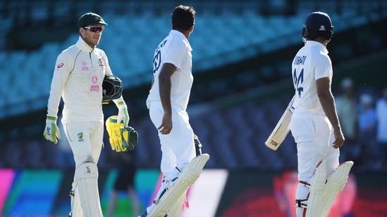 Australia's captain Tim Paine speaks to India's Ravichandran Ashwin and Hanuma Vihari after a draw on day 5 of the third cricket test match between Australia and India at the Sydney Cricket Ground, Sydney, Australia, January 11, 2021. Picture taken January 11, 2021. (REUTERS)