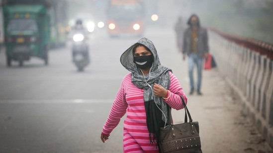 A woman out on a foggy winter morning at Kirti Nagar on January 12. Air pollution in the city on January 14 also registered poor numbers with the System of Air Quality and Weather Forecasting and Research (SAFAR) reporting an overall AQI of 346, falling in the very poor category.(Sanchit Khanna / HT Photo)