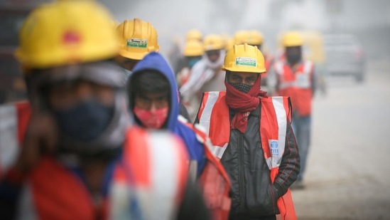Construction workers out on a foggy winter morning at Zakhira in New Delhi on January 12. “There is intense snowfall being reported from states like Jammu Kashmir, Himachal Pradesh and Uttarakhand, and currently Delhi is receiving north-westerly winds from these snow-clad states” said Kuldeep Srivastava, head of IMD’s regional weather forecasting centre.(Sanchit Khanna / HT Photo)