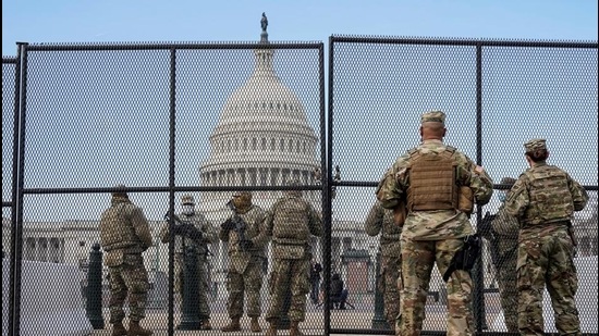 National Guard soldiers maintain a watch over the US Capitol after the House of Representatives impeached US President Donald Trump on January 14. (REUTERS) National Guard soldiers maintain a watch over the US Capitol after the House of Representatives impeached US President Donald Trump on January 14. (REUTERS)
