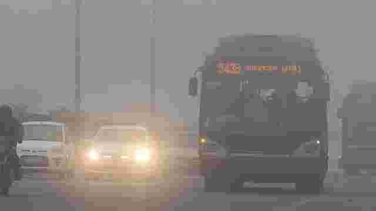 Traffic moves slowly through a dense fog in New Delhi. Cold wave conditions continued across North India claiming 165 lives this winter. AFP PHOTO / Prakash Singh Traffic moves slowly through a dense fog in New Delhi. Cold wave conditions continued across North India claiming 165 lives this winter. AFP PHOTO / Prakash Singh