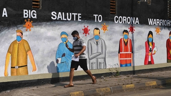 A pedestrian walks past a wall mural painted to thank frontline workers from various professions fighting against the spread of the Covid-19 coronavirus, in Mumbai on January 13. Meanwhile, the number of people infected with the new UK variant of SARS-CoV-2 in India has reached 109, the Ministry of health and family welfare said on January 13, up from 102 a day prior.(Indranil Mukherjee / AFP)