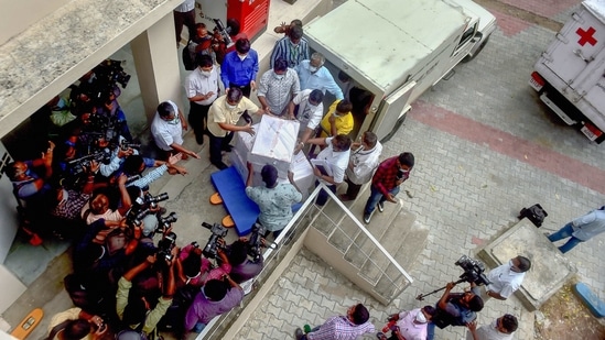 Workers unloading the first batch of Covishield vaccine from the Serum Institute of India at a storage facility in Chennai on January 12. Vaccine doses have been transported to specialized facilities from Pune and Hyderabad to various cities across the country, including Delhi.(R Senthil Kumar / AP)