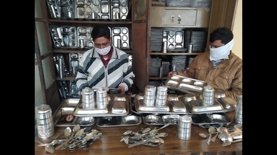 Ludhiana MC employees managing utensils in the 'Bartan Bhandar' established at the Zone C office of the civic body in Ludhiana on Thursday. (HT FILE) Ludhiana MC employees managing utensils in the 'Bartan Bhandar' established at the Zone C office of the civic body in Ludhiana on Thursday. (HT FILE)