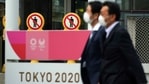 People wearing protective masks to help curb the spread of the coronavirus walk near a banner of Tokyo 2020 Olympics and Paralympic games in Tokyo Friday, Jan. 15, 2021. (AP) People wearing protective masks to help curb the spread of the coronavirus walk near a banner of Tokyo 2020 Olympics and Paralympic games in Tokyo Friday, Jan. 15, 2021. (AP)