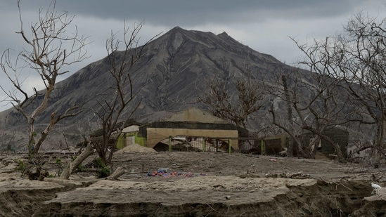 Damaged structures seen at the Taal Volcano island, a year after the volcano erupted, in Batangas province, Philippines on January 12. The island is a ghost town, its trees just dead sticks in a gray landscape, its homes and school ash-covered and damaged by continuing earthquakes and the explosive volcanic eruption that occurred one year ago.(Lisa Marie David / REUTERS)