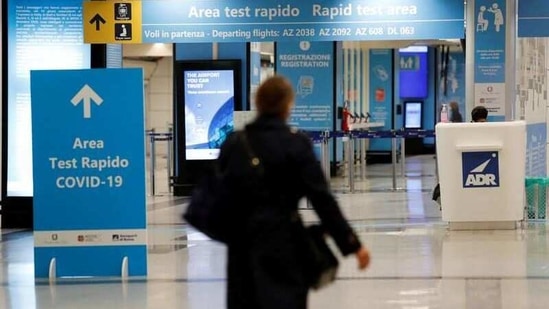 A person walks near of a Covid-19 test area at Fiumicino airport, Italy. (REUTERS)