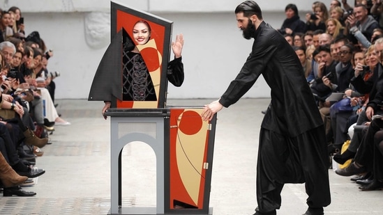 A magician performs the trick with a model.(REUTERS)