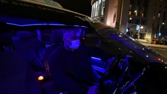 Greek driver Konstantinos Bekios is seen in his taxi that he turned into a 'night club', amid the coronavirus disease (COVID-19) pandemic, in Thessaloniki, Greece, January 14, 2021.(Reuters)