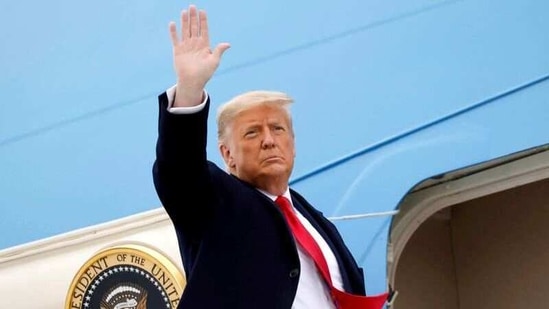 US President Donald Trump salutes as he boards Air Force One at Valley International Airport after visiting the US-Mexico border wall, in Harlingen, Texas, US. (Reuters)
