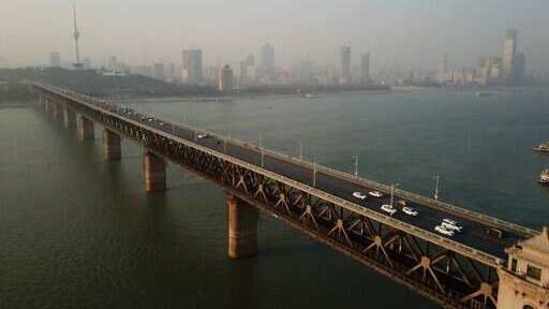 In this aerial photo, vehicles drive across the Wuhan Changjiang Bridge in Wuhan in central China's Hubei Province, Friday, Jan. 15, 2021. A global team of researchers arrived on Thursday in the Chinese city where the coronavirus pandemic was first detected to investigate its origins amid uncertainty about whether Beijing might try to prevent embarrassing discoveries. (AP Photo/Sam McNeil)(AP) In this aerial photo, vehicles drive across the Wuhan Changjiang Bridge in Wuhan in central China's Hubei Province, Friday, Jan. 15, 2021. A global team of researchers arrived on Thursday in the Chinese city where the coronavirus pandemic was first detected to investigate its origins amid uncertainty about whether Beijing might try to prevent embarrassing discoveries. (AP Photo/Sam McNeil)(AP)