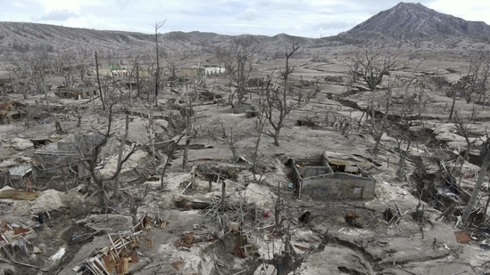 Photos: Only ash, shells of homes left on Philippine volcano island ...