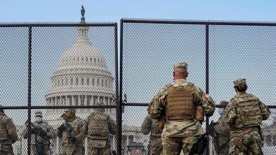 National Guard soldiers maintain a watch over the US Capitol after the House of Representatives impeached US President Donald Trump on January 14. (REUTERS) National Guard soldiers maintain a watch over the US Capitol after the House of Representatives impeached US President Donald Trump on January 14. (REUTERS)
