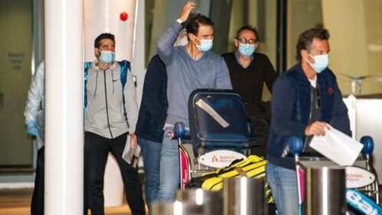 Spain's Rafael Nadal, center, arrives at Adelaide Airport ahead of the Australian Open tennis championship, Adelaide, Australia, Thursday, Jan. 14, 2021. Arriving players will serve a 14-day quarantine period ahead of the first Grand slam tennis tournament that is set to get underway on February 8 in Melbourne. (Morgan Sette/AAP Image via AP)(AP)