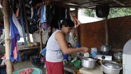 Luisa Silva, a former resident of Taal volcano, arranges her kitchen at their tent at a relocation site in Balete, on January 10. Silva, who wishes to return, used to live at the foot of the Taal volcano and told AP that life will never be the same. “Right now life is very hard, we are not used to this. This is where we have experienced things that we have never experienced before, we don’t know where to start,” she said.(Aaron Favila / AP)