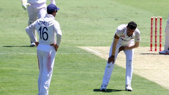 India's Navdeep Saini, right, reacts after injuring his leg while bowling during play on the first day of the fourth cricket test between India and Australia at the Gabba, Brisbane, Australia, Friday, Jan. 15, 2021. (AP) India's Navdeep Saini, right, reacts after injuring his leg while bowling during play on the first day of the fourth cricket test between India and Australia at the Gabba, Brisbane, Australia, Friday, Jan. 15, 2021. (AP)