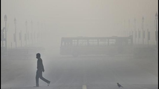 A morning walker near India Gate, New Delhi. AQI was in the severe category on Friday in NW India including Delhi, Faridabad, Ghaziabad, Greater Noida, and Noida. (HT file)