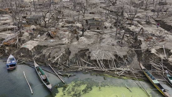 Damaged houses are seen at the Taal volcano almost a year after it erupted, in Batangas province on January 10. A popular tourist destination set in the middle of a lake, Taal erupted on January 12, 2020.(Aaron Favila / AP)