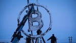 A bitcoin sculpture made from scrap metal is installed outside the BitCluster cryptocurrency mining farm in Norilsk, Russia.(Bloomberg)