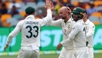 Australia's Nathan Lyon, left, is congratulated by teammate's Matthew Wade and Marnus Labuschagne, left, after taking the wicket of India's Rohit Sharma during play on day two of the fourth cricket Test between India and Australia at the Gabba, Brisbane, Australia, Saturday, Jan. 16, 2021.(AP) Australia's Nathan Lyon, left, is congratulated by teammate's Matthew Wade and Marnus Labuschagne, left, after taking the wicket of India's Rohit Sharma during play on day two of the fourth cricket Test between India and Australia at the Gabba, Brisbane, Australia, Saturday, Jan. 16, 2021.(AP)