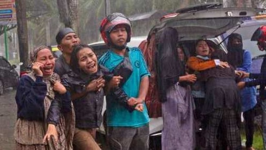 People react (left) as the body of a relative is retrieved from the rubble of a building in Mamuju, West Sulawesi; residents inspect (right) damaged buildings in Mamuju.(AP) People react (left) as the body of a relative is retrieved from the rubble of a building in Mamuju, West Sulawesi; residents inspect (right) damaged buildings in Mamuju.(AP)
