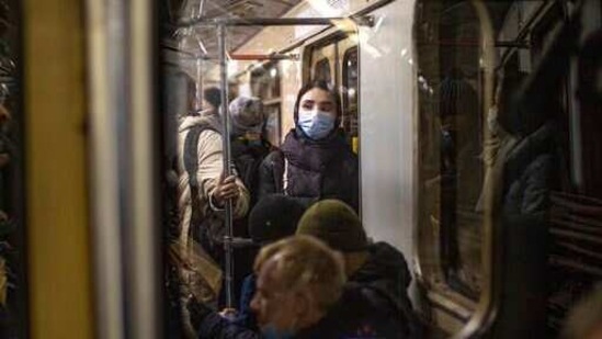 A woman wearing a face mask to help curb the spread of the coronavirus rides a subway car in Moscow, Russia,(AP) A woman wearing a face mask to help curb the spread of the coronavirus rides a subway car in Moscow, Russia,(AP)