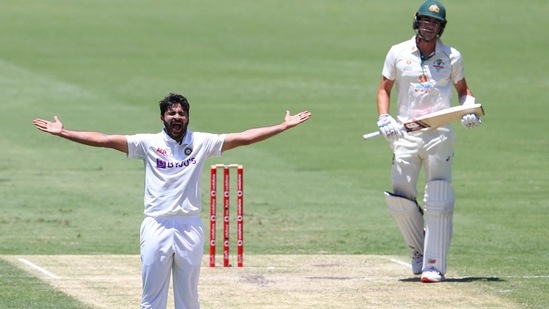 India's Shardul Thakur, left, appeals successfully for the wicket of Australia's Pat Cummins, right, during play on day two of the fourth cricket test between India and Australia at the Gabba, (AP) India's Shardul Thakur, left, appeals successfully for the wicket of Australia's Pat Cummins, right, during play on day two of the fourth cricket test between India and Australia at the Gabba, (AP)