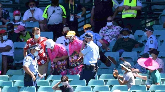 Police remove a group of spectators from their seats after Mohammed Siraj of India complained to umpires of being racially abused during day four of the third test match between Australia and India at the SCG, Sydney.(via REUTERS)