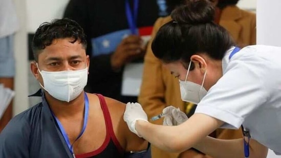 Sanitation worker Manish Kumar, who according to the officials is the first person in the country vaccinated against the Covid-19 in Delhi.(REUTERS)