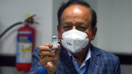 Union Health Minister Harsh Vardhan shows a dose of COVAXIN developed by Bharat Biotech at AIIMS in New Delhi on Saturday as the first phase of vaccination begins across the country. (ANI Photo) Union Health Minister Harsh Vardhan shows a dose of COVAXIN developed by Bharat Biotech at AIIMS in New Delhi on Saturday as the first phase of vaccination begins across the country. (ANI Photo)