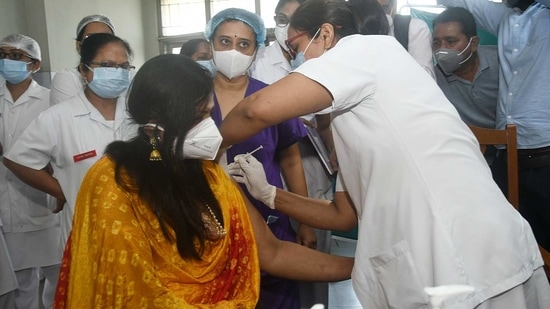 A woman gets a dose of COVID-19 vaccine by a health worker at Civil Hospital, in Surat on Saturday. (ANI photo) A woman gets a dose of COVID-19 vaccine by a health worker at Civil Hospital, in Surat on Saturday. (ANI photo)
