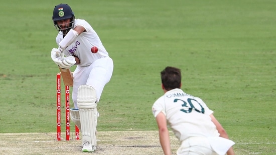 India's Cheteshwar Pujara plays at the ball bowled by Australia's Pat Cummins during play on day two of the fourth cricket test between India and Australia at the Gabba, Brisbane, Australia, Saturday, Jan. 16, 2021. (AP Photo/Tertius Pickard)(AP) India's Cheteshwar Pujara plays at the ball bowled by Australia's Pat Cummins during play on day two of the fourth cricket test between India and Australia at the Gabba, Brisbane, Australia, Saturday, Jan. 16, 2021. (AP Photo/Tertius Pickard)(AP)