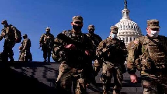 Members of the National Guard walk past the dome of the Capitol Building on Capitol Hill in Washington.(AP) Members of the National Guard walk past the dome of the Capitol Building on Capitol Hill in Washington.(AP)