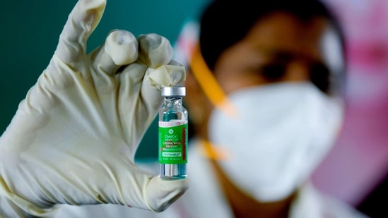 A medical worker displays a Covishield vaccine vial at the government Rajaji hospital in Madurai on January 16. The inoculation campaign across the world’s second-most populous country will showcase whether Covid-19 can be swiftly tamed in nations with disjointed health and transportation networks.( Arun Sankar / AFP)