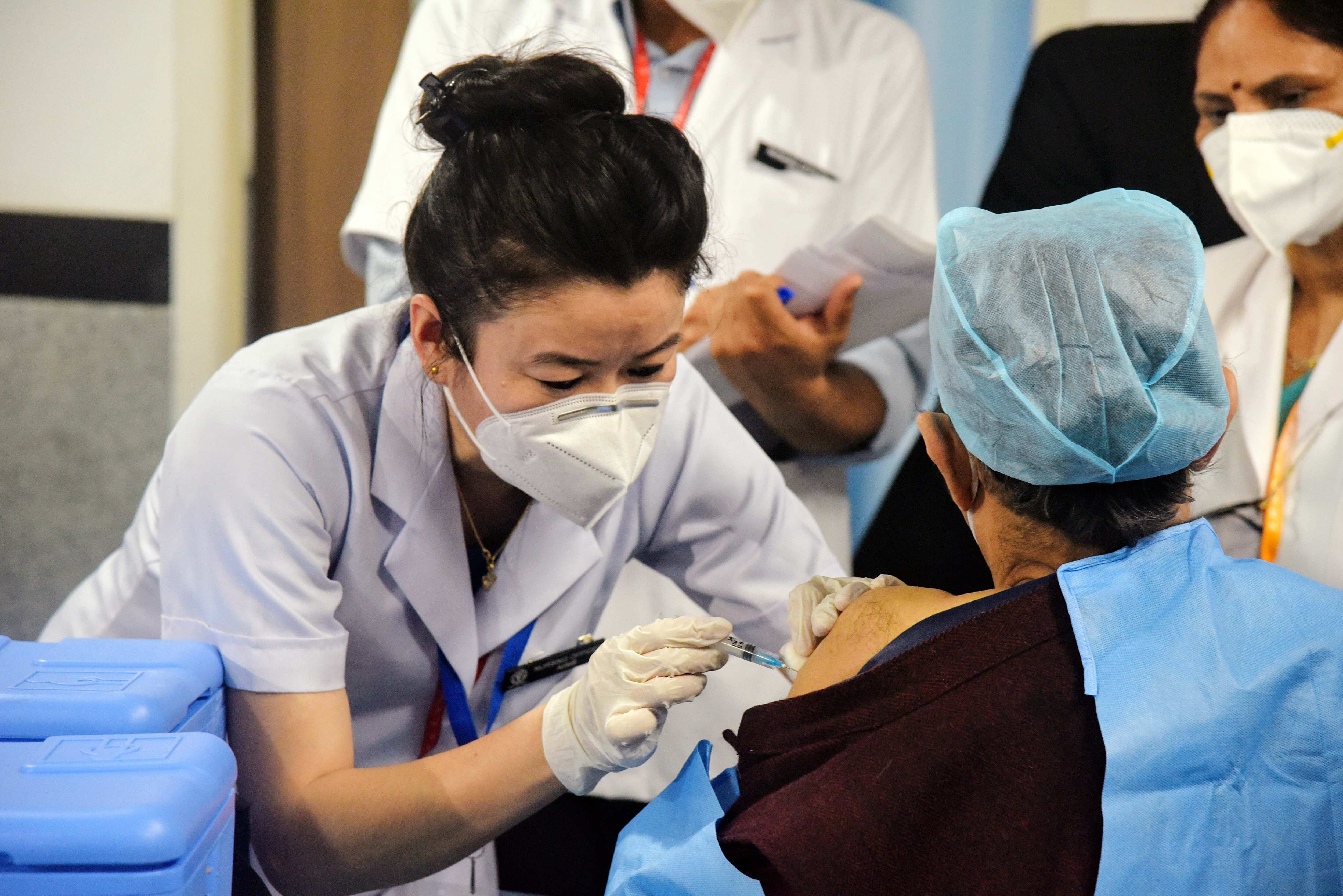A health worker receives a Covid19 vaccine shot, at AIIMS in New Delhi.