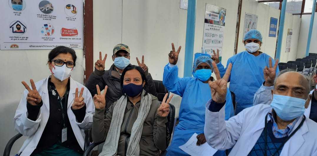 Volunteers showing victory sign after the Covid 19 vaccination is given to them at DadaDev Hospital near Dwarka. (HT Photo/ Vipin Kumar)